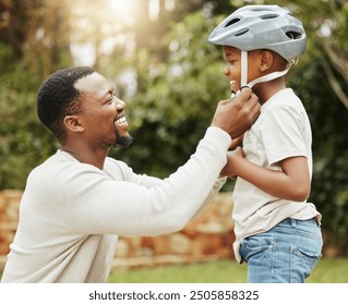 Father, son and teaching with helmet for safety on bicycle or learning to ride bike in nature. Happy black man, dad and little boy with smile for protection, adjustment or preparation before cycling - Powered by Shutterstock