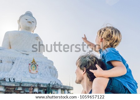 Father and son tourists on the Big Buddha statue. Was built on a high hilltop of Phuket Thailand Can be seen from a distance