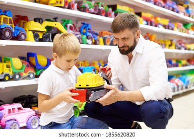 Father And Son In A Toy Store.