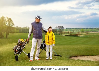 Father with son are training at golf course 