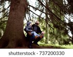 father and son under tree