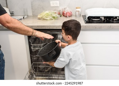 Father and son unloading dishwasher together. Chores concept. - Powered by Shutterstock