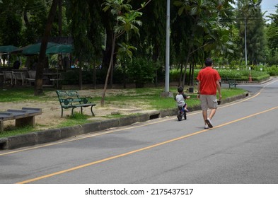 Father and son are vacationing in the park.