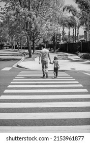 Father And Son Walk On Zebra Crossing. Family Value. Parent Leading Small Child Boy