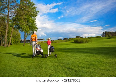 Father with son are walking at golf field