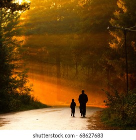 Father And Son Walking In The Sunlight