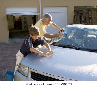 Father And Son Washing A Car