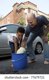 Father And Son Washing A Car