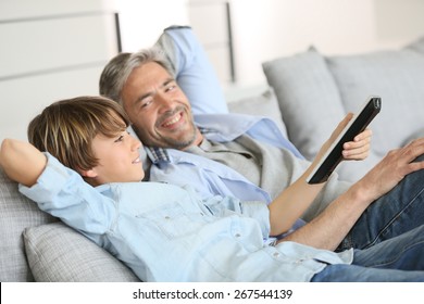 Father and son watching tv together