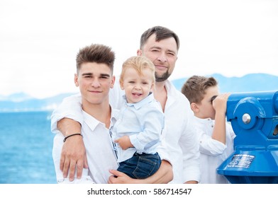 Father And Sons At Sea. Family On Viewing Platform Near The Coin Operated Binoculars. Tourism And Family Concept. Spain. Costa Brava. 