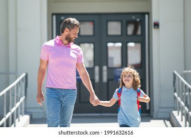 Father Supports And Motivates Son. Kid Going To Primary School. Parent With Child In Front Of School Gates.