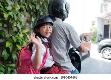Father Taking His Daughter To School By Motorcycle In The Morning. Asian Primary Student Wearing Uniform Going Back To School