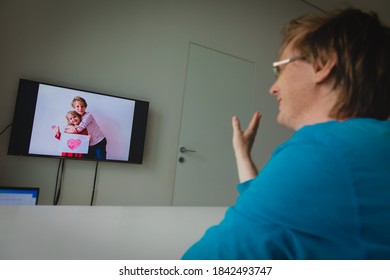 father taking present from kids during online call