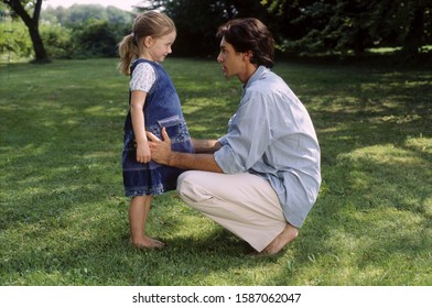 Father Talking To Daughter Outdoors