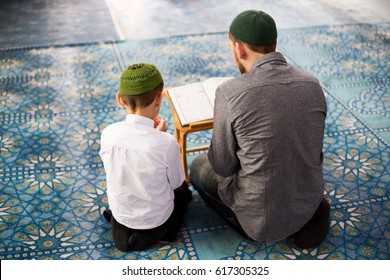 The Father Teaches The Child To Read The Quran