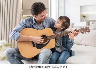 Father teaches his son to play the guitar - Powered by Shutterstock