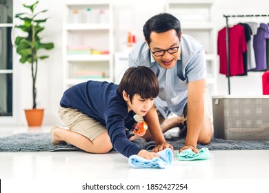 Father Teaching Asian Kid Little Boy Son Use Disinfectant Spray Bottle Cleaning And Washing Floor Wiping Dust With Rags While Cleaning House Together At Home