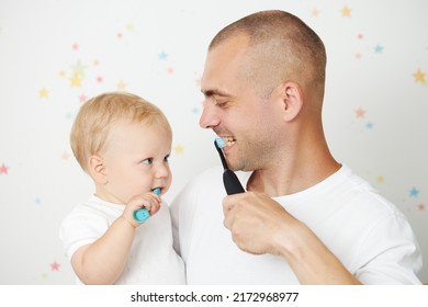 Father Teaching Baby Boy Brushing Teeth. The Concept Of Oral Hygiene From The First Tooth