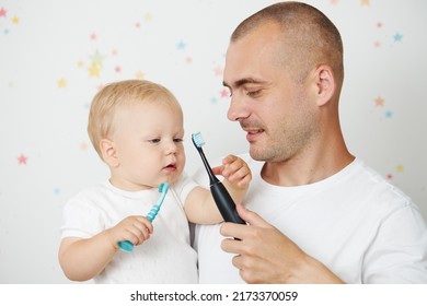 Father Teaching Baby Boy Brushing Teeth. The Concept Of Oral Hygiene From The First Tooth