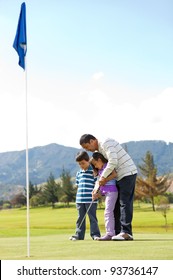 Father teaching his kids how to playing golf