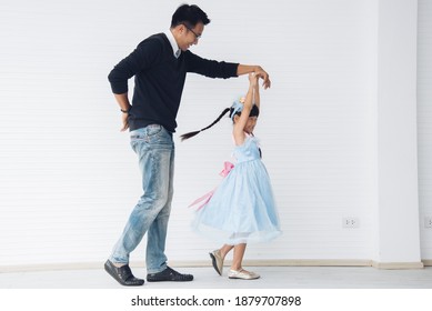 Father Is Teaching His Little Daughter To Dance In The Halls Of The House. Happy Holidays, Family Relationships.