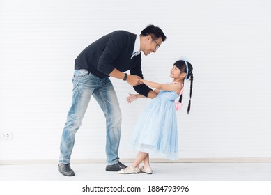 Father Is Teaching His Little Daughter To Dance In The Halls Of The House. Happy Holidays, Family Relationships.