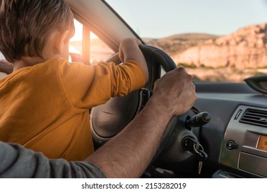 father teaching his little son to drive. playing driver in daddy's car. Father's day. parenting concept	
 - Shutterstock ID 2153282019