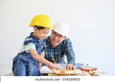 Father was teaching his son for construction working renovated house  they wearing casual shirt  happy family relationship concept 