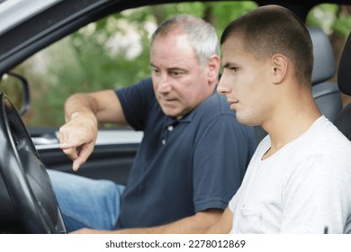 father teaching his son to drive a car - Powered by Shutterstock