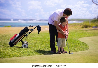 Father teaching his son how to play golf.