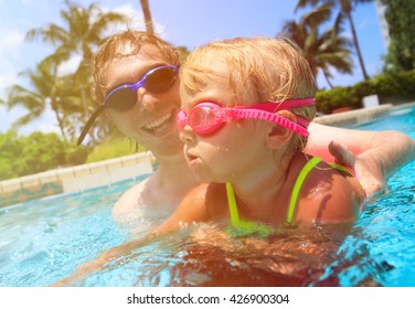 Father Teaching Little Daughter To Swim