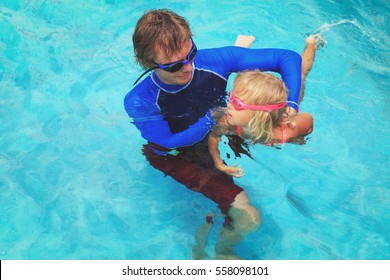 Father Teaching Little Daughter To Swim