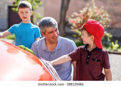 Father Teaching Son Cleaning The Spotlight, Family Car Wash