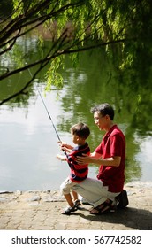 Father Teaching Son To Fish