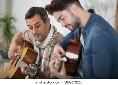 Father Teaching Son The Guitar