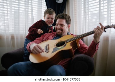 Father Teaching Son How To Play Guitar