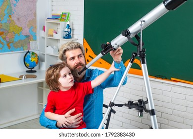 Father Teaching Son. Kids Science Education Concept. Astronomy Telescope. School Kids Against Green Chalkboard