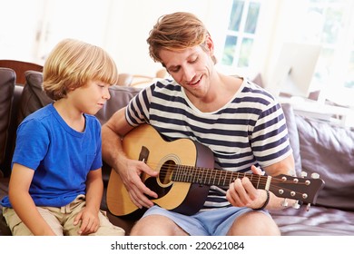 Father Teaching Son To Play Guitar