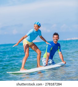 Father Teaching Surfing To His Cute Teen Girl