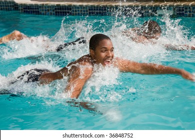 Father, Teen Son And The Big Race In The Backyard Swimming Pool