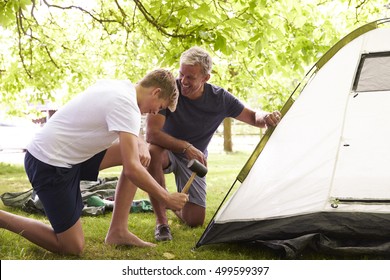 Father And Teenage Son Putting Up Tent On Camping Trip - Shutterstock ID 499599397