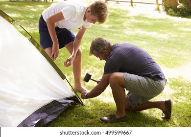 Father And Teenage Son Putting Up Tent On Camping Trip - Powered by Shutterstock