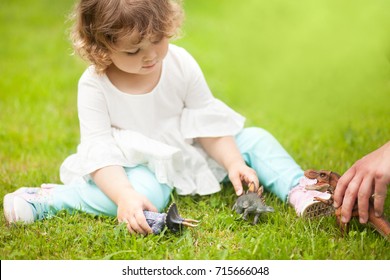 father tell his cute toddler daughter about dinosaurs. family leisure outdoors. boys toys for girl. concept of father and daughter relationship and friendship. loving caring parents.  - Powered by Shutterstock