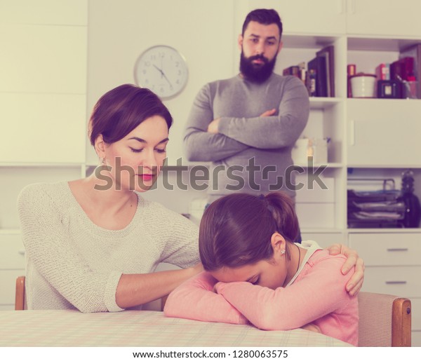 Father telling off his wife and daughter for disobedience at home image photo