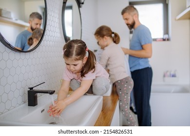 Father With Three Little Children In Bathroom, Morning Routine Concept.