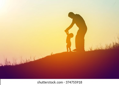 Father Took The Baby Learn To Walk At Sunset.