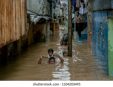 A Father tried to save his children and family during the flood that attack Kampung Duri & Kampung Pulo, Jakarta, Indonesia on 2 February 2018. 