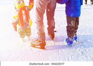 Father With Two Kids Skating In Winter, Family Winter Sport