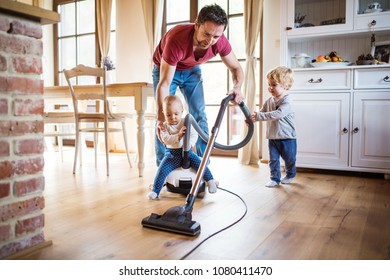Father and two toddlers doing housework.