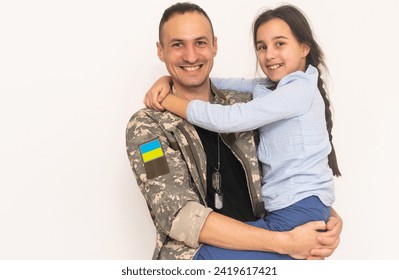 Father in Ukrainian military uniform and his daughter. Family reunion - Powered by Shutterstock